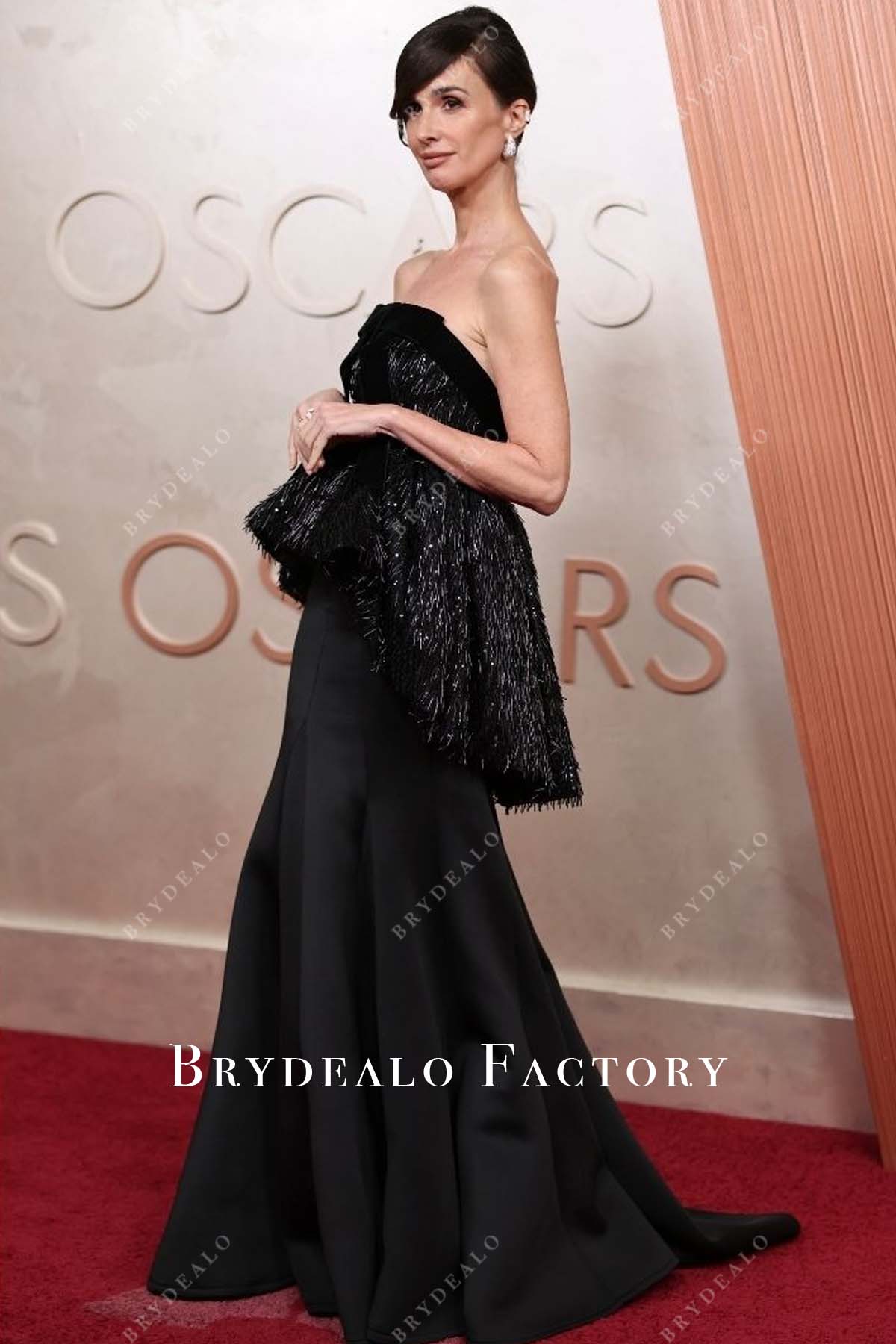 Paz Vega 2025 Oscars red carpet high low peplum dress