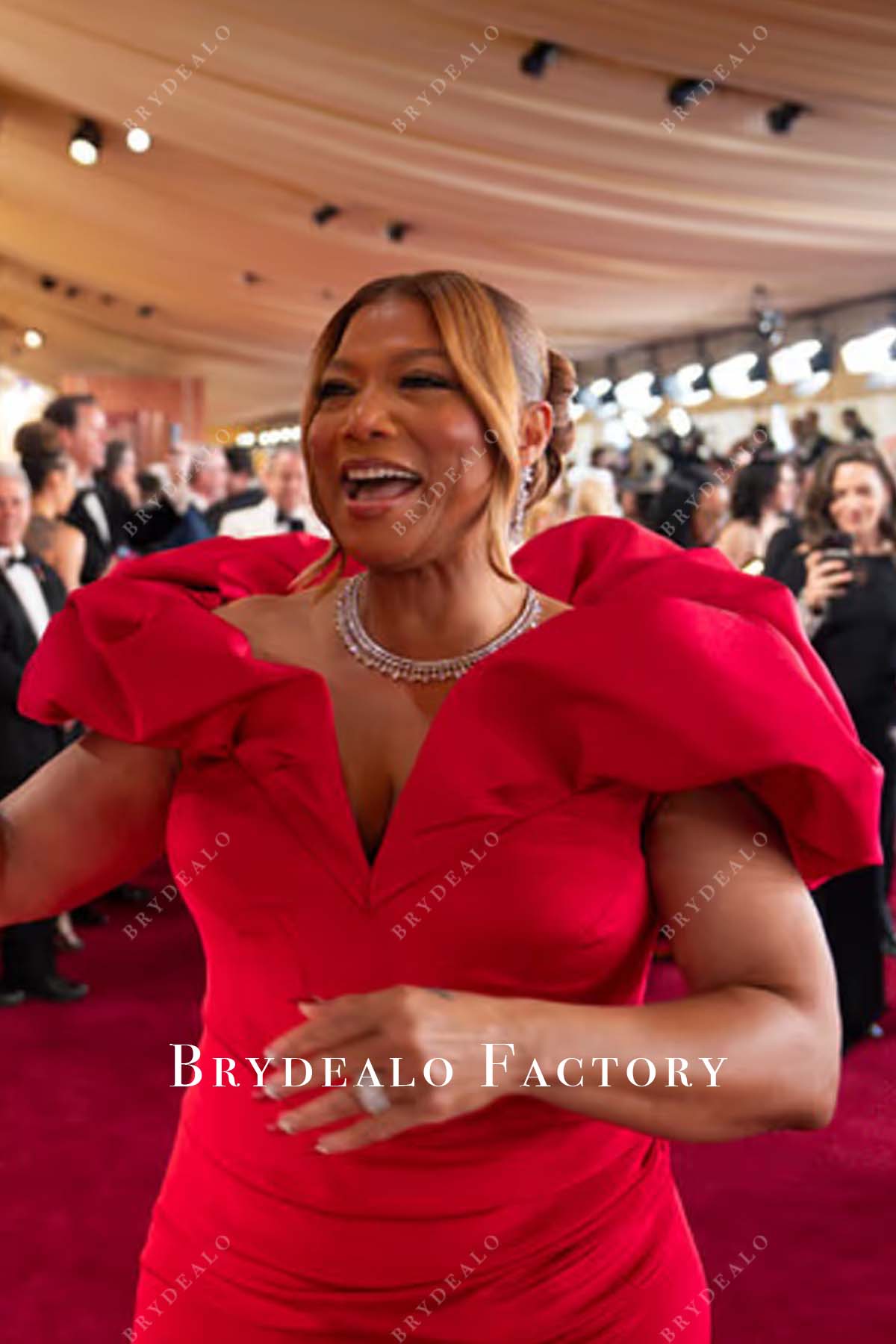 Queen Latifah red 2025 Oscars red carpet v neck dress