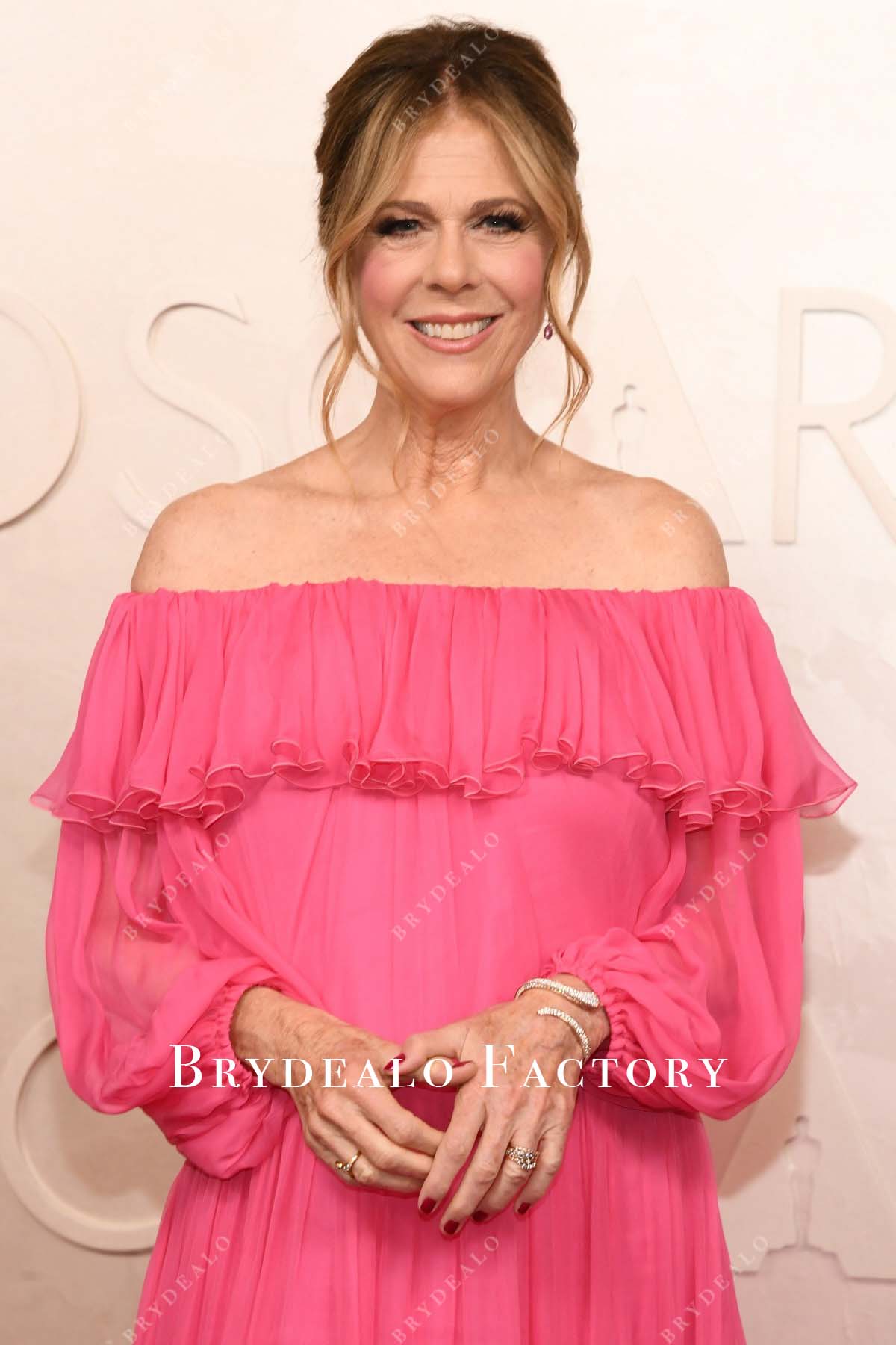 Rita Wilson hot pink 2025 Oscars red carpet straight across dress