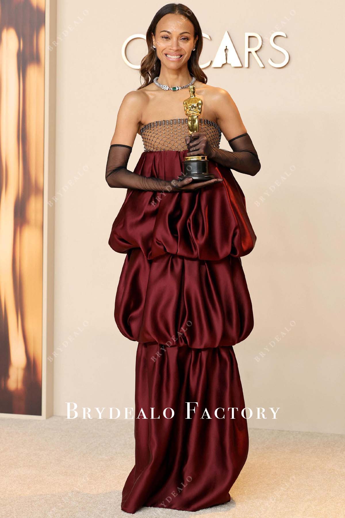 Zoe Saldaña burgundy 2025 Oscars red carpet dress