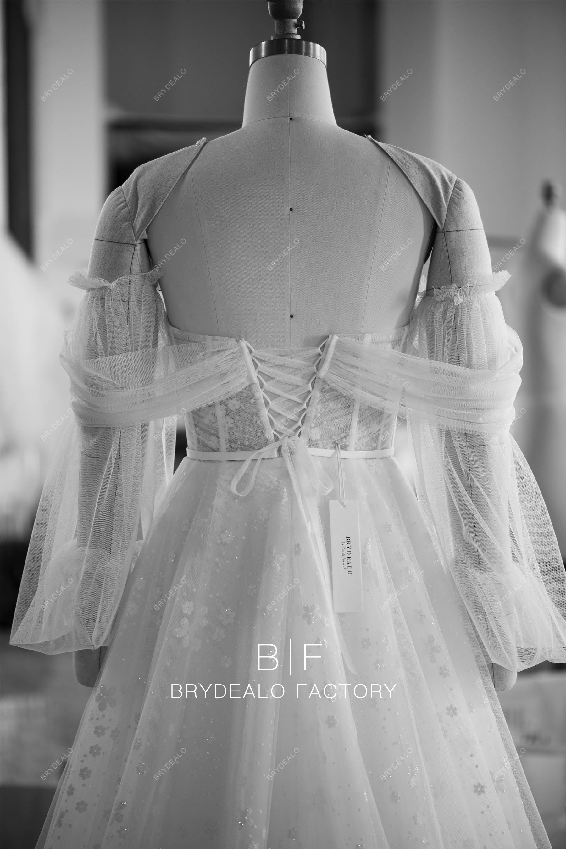 tailored off shoulder sleeved lace up wedding dress