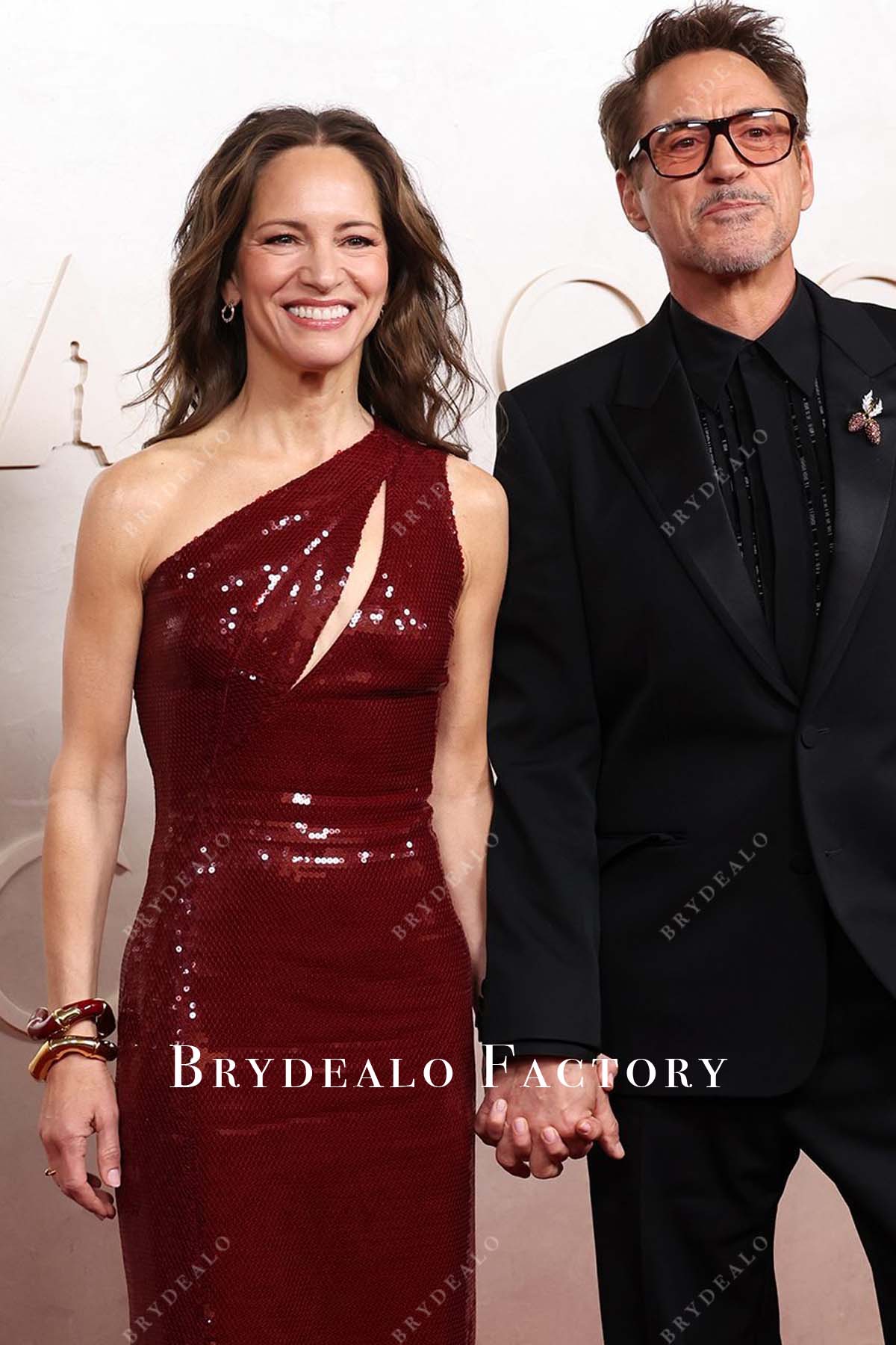 Susan Downey burgundy 2025 Oscars red carpet cutout dress
