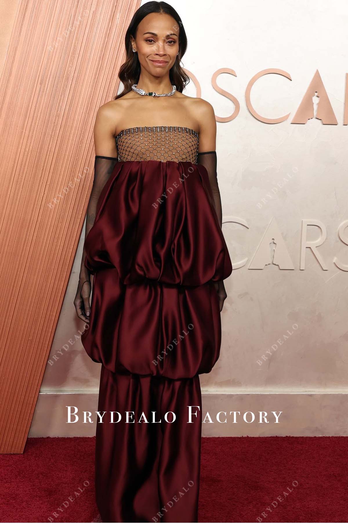 Zoe Saldaña burgundy 2025 Oscars red carpet dress
