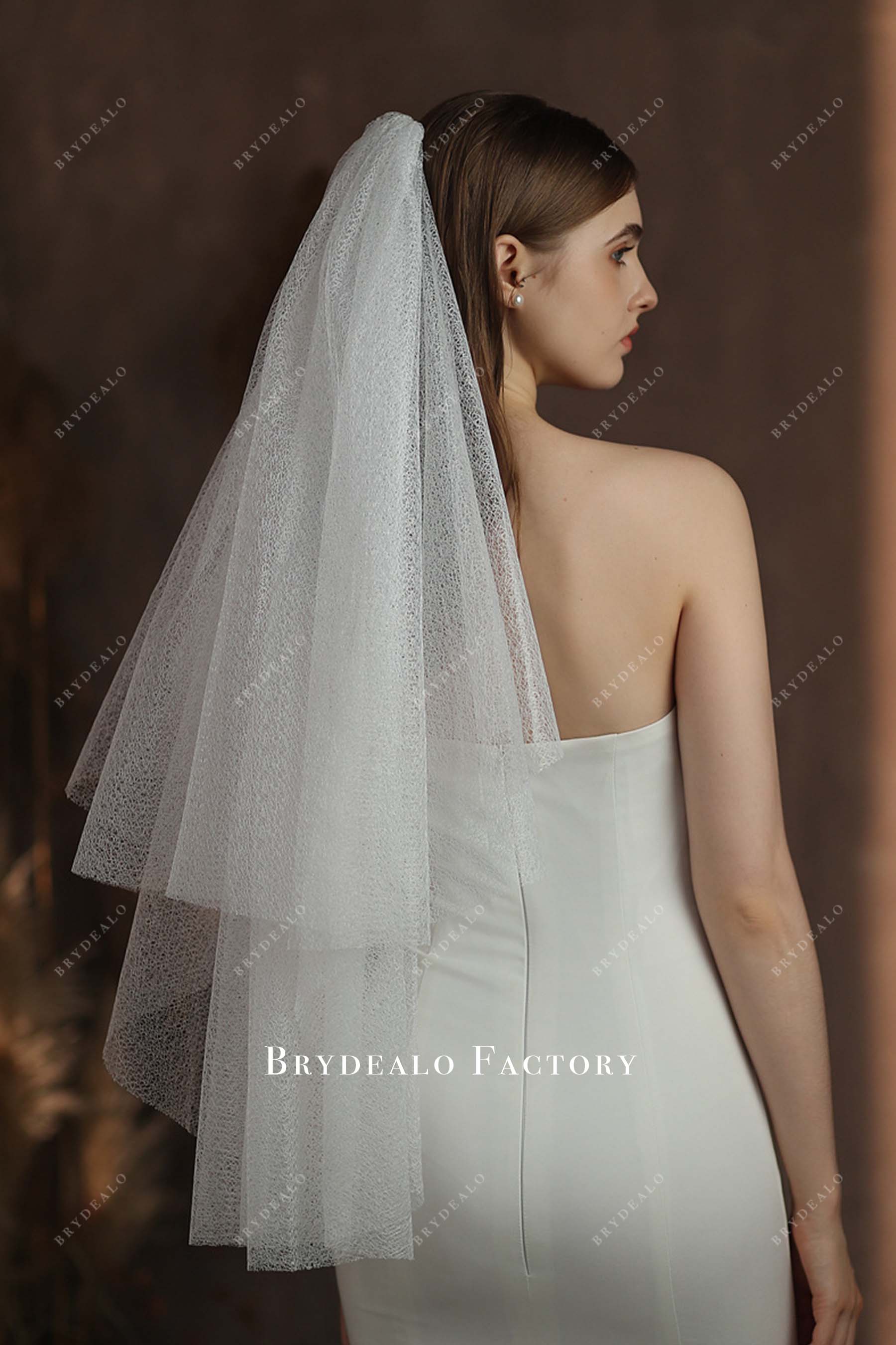 designer with comb bridal veil