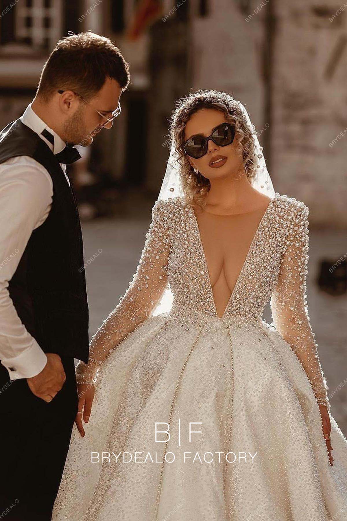plunging neck luxury pearls sleeved bridal gown