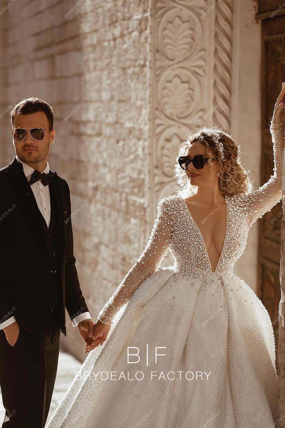 sexy plunging neck sheer sleeves destination bridal gown