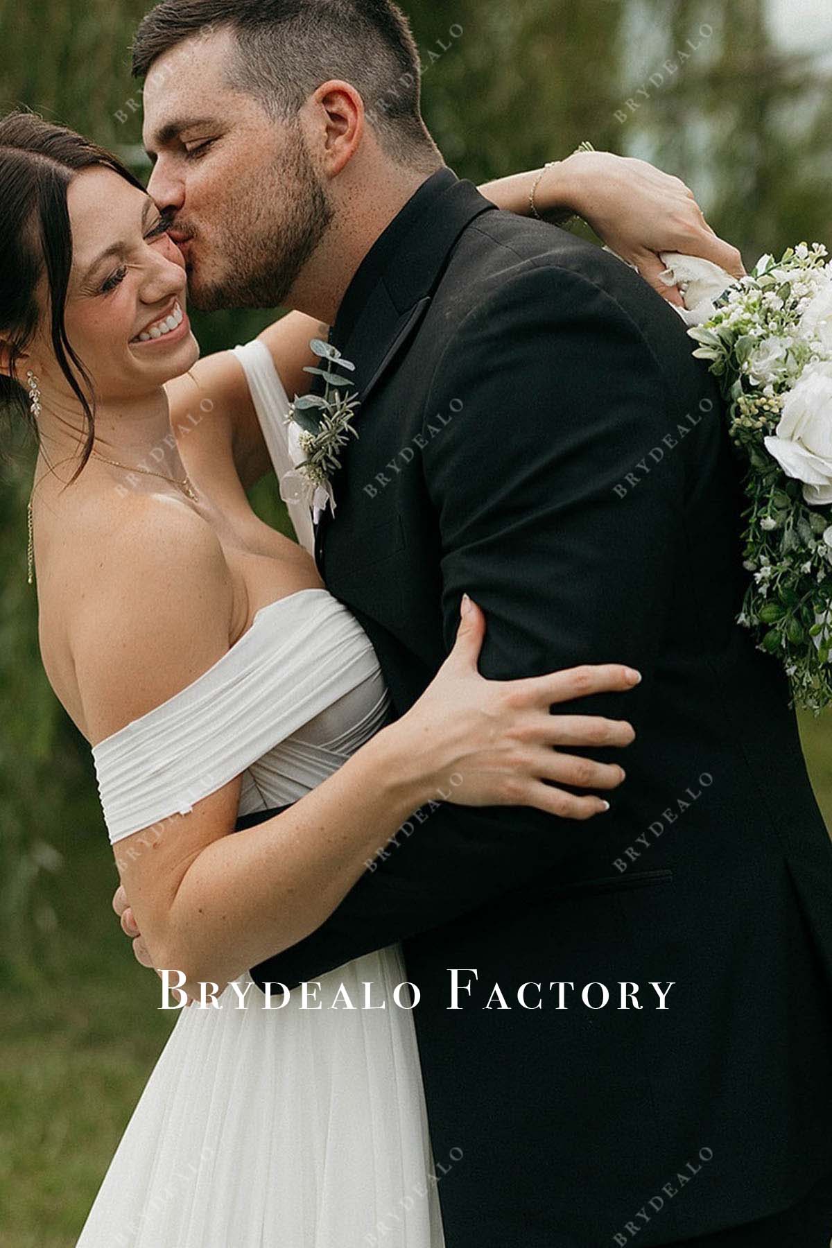 white pleated off shoulder wedding dress