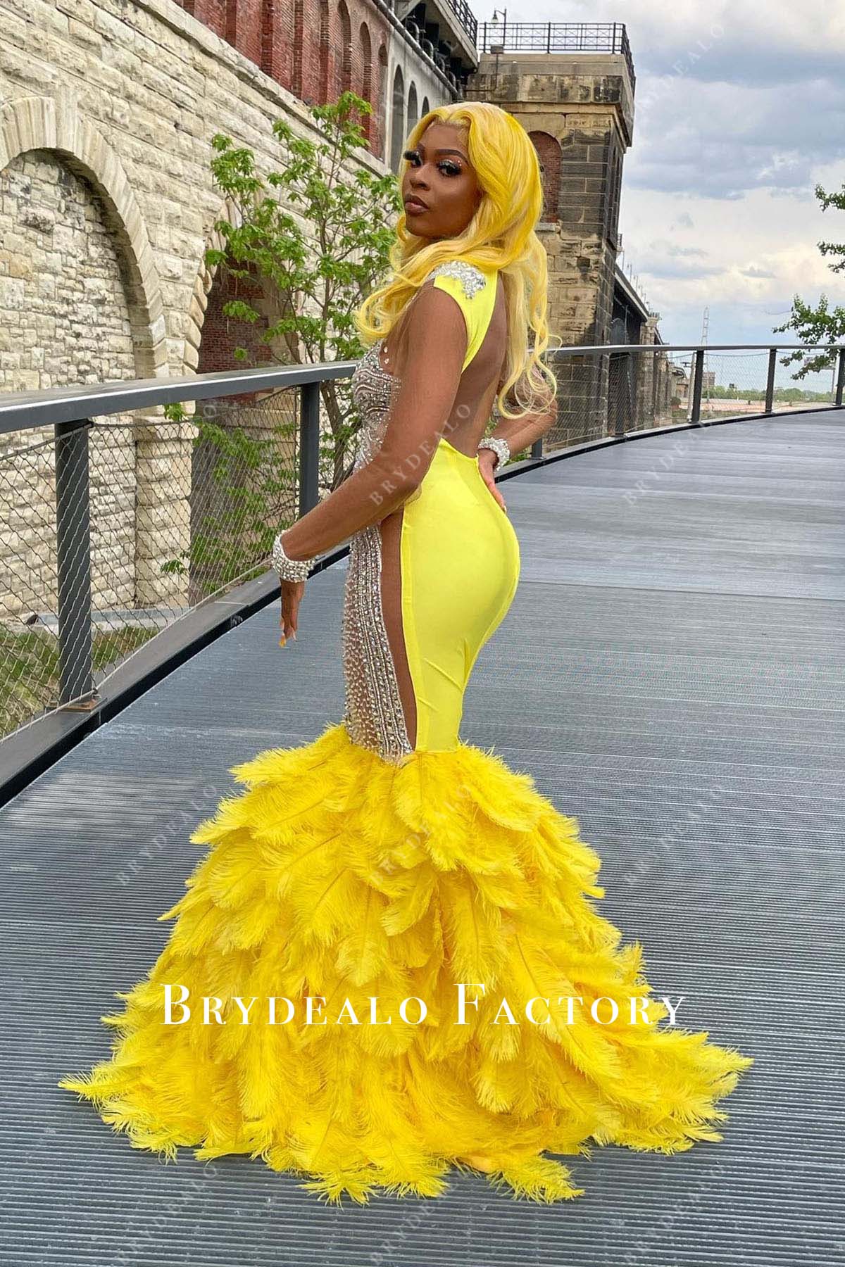 yellow feathered trumpet prom dress