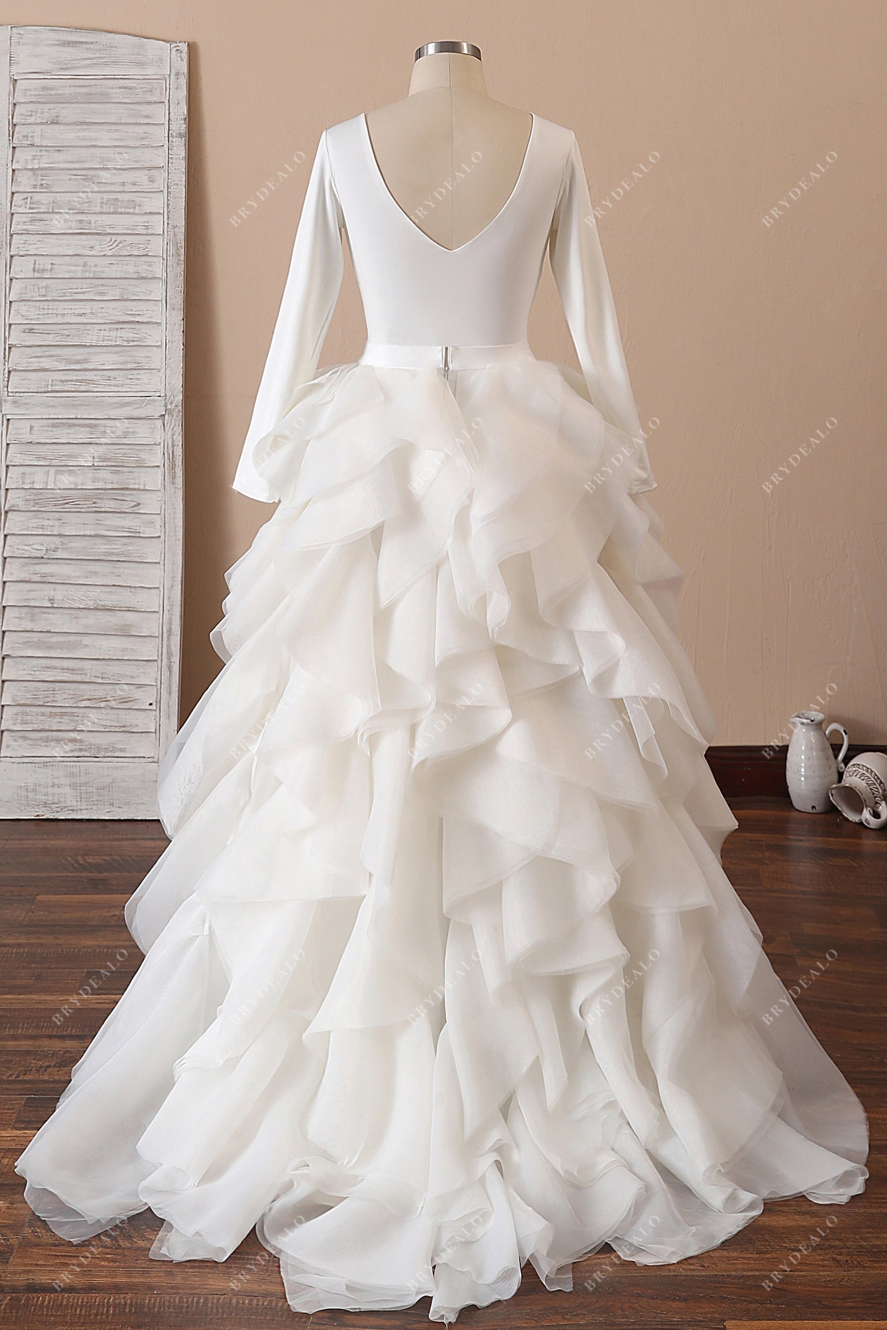 open back ivory crepe sleeved ruffled organza bridal gown