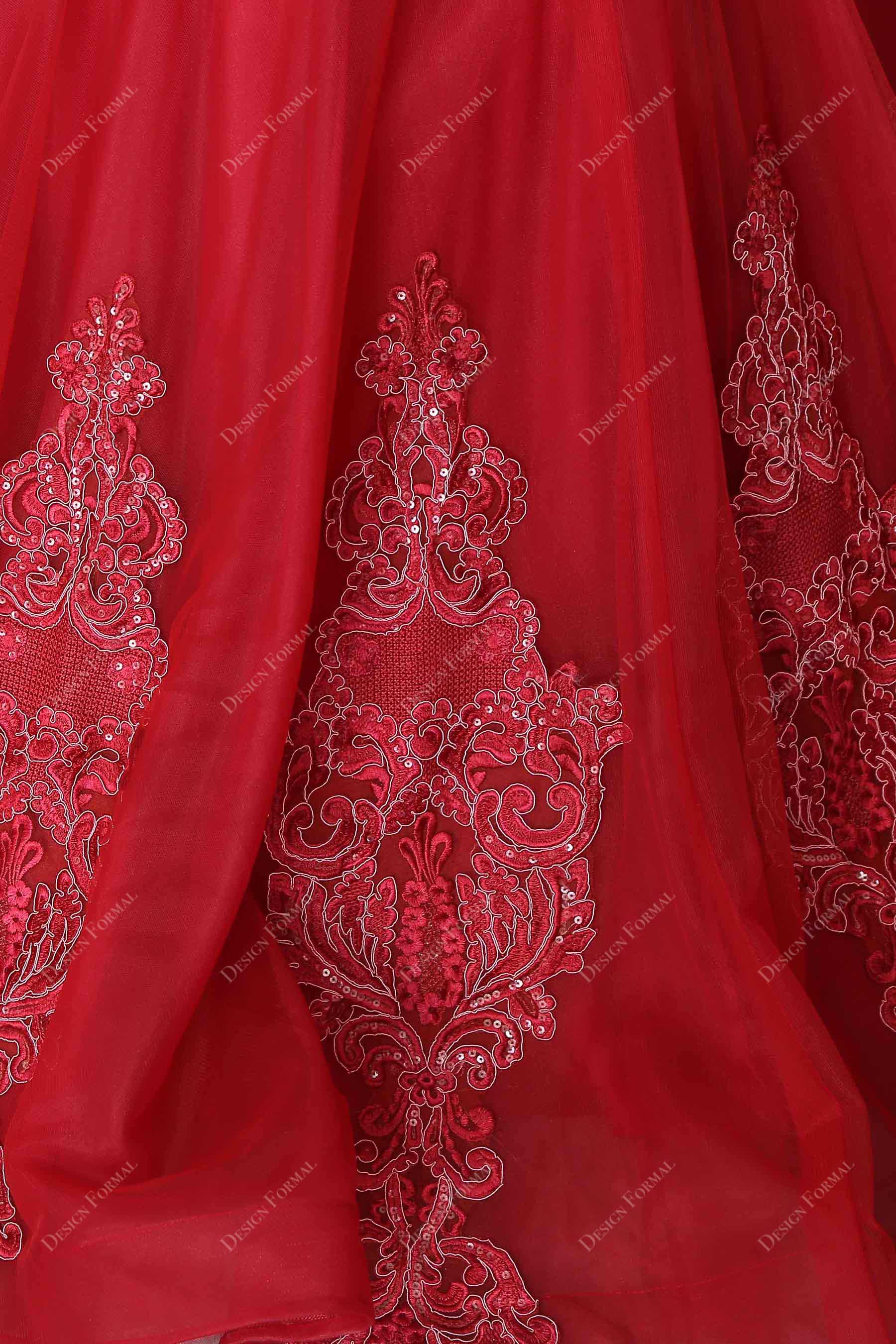 beaded appliques decorating red tulle