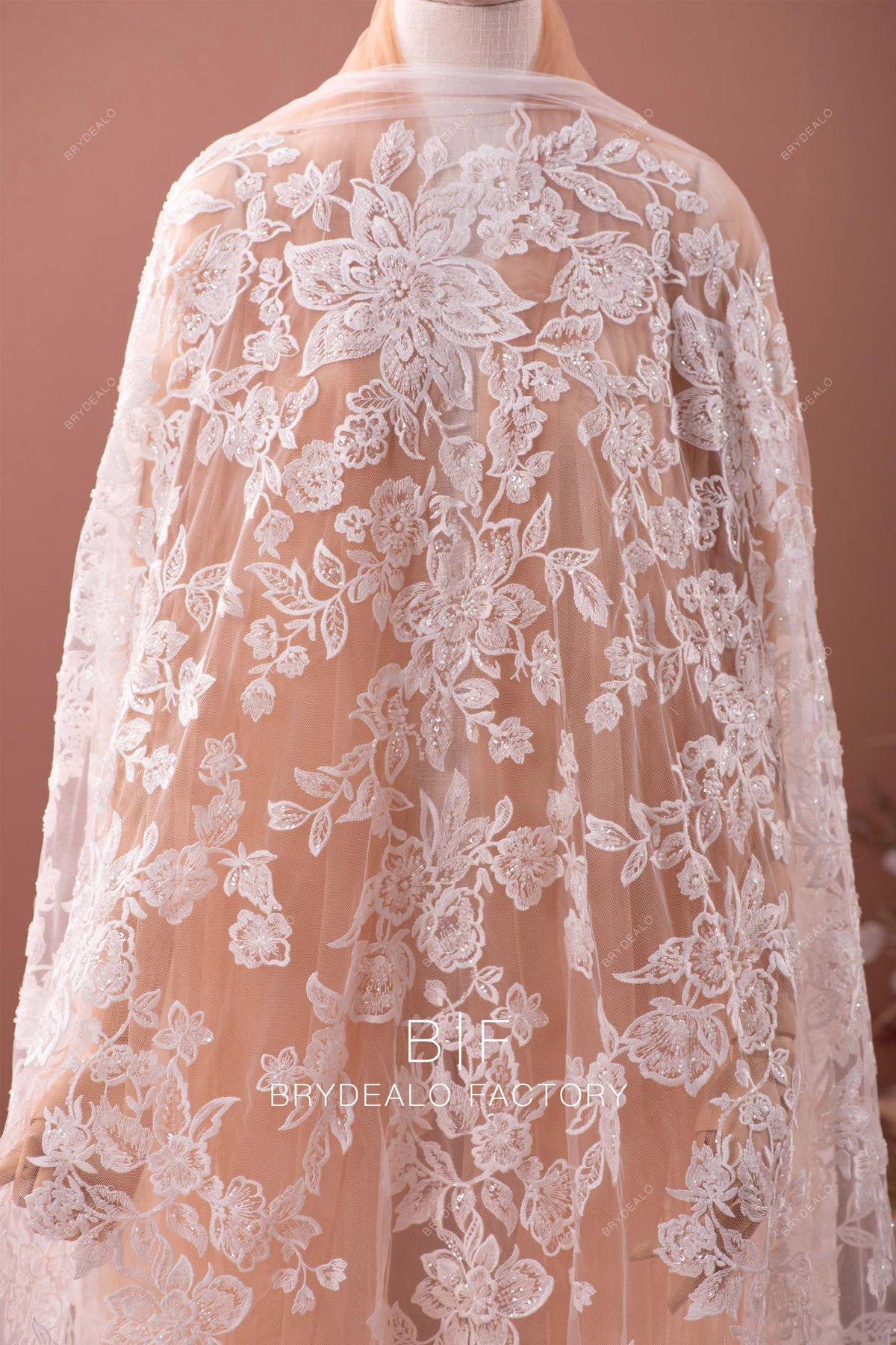 Black flowers embroider and heavy beaded on a mesh lace fabric-sold by the yard.
