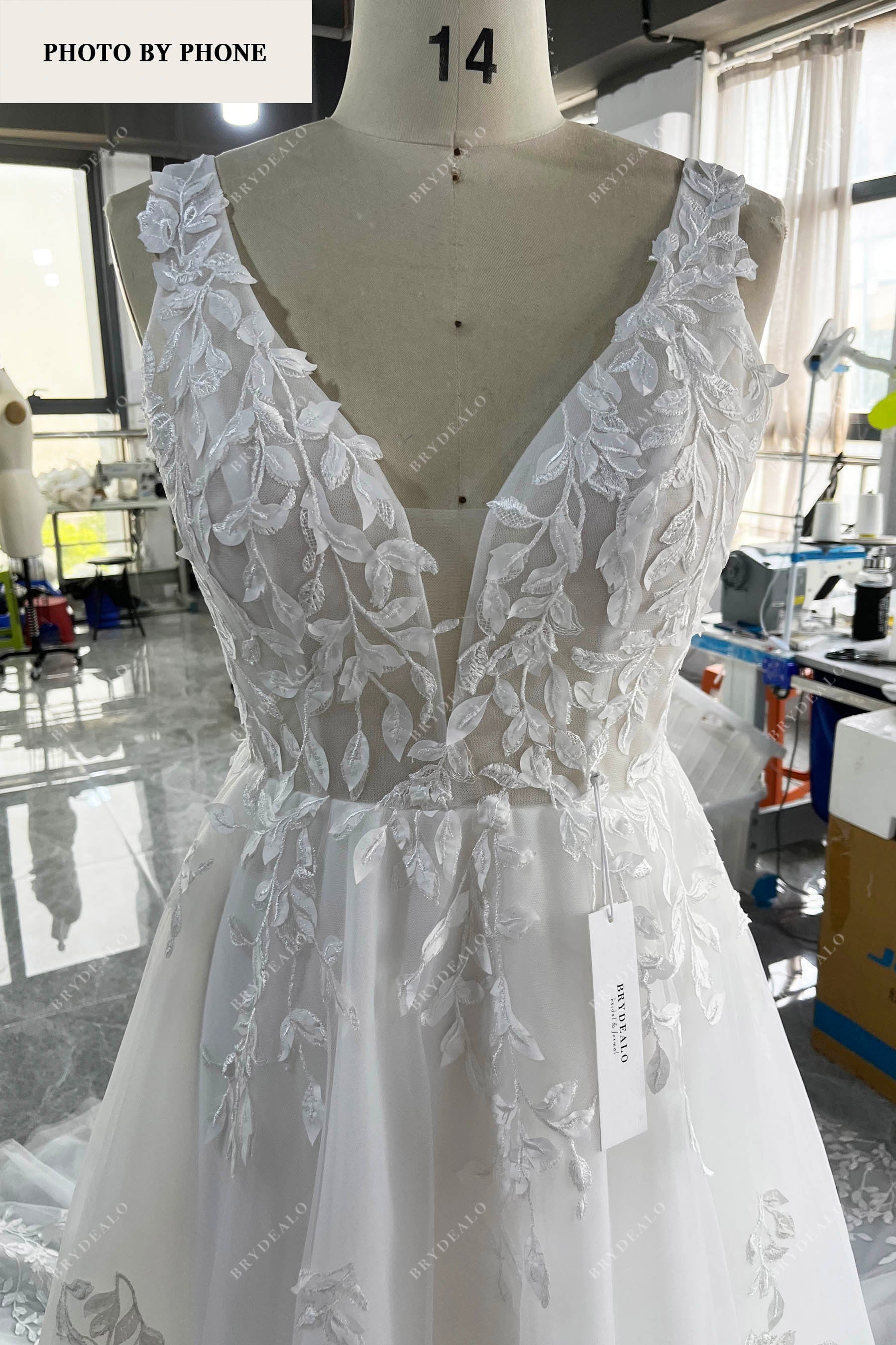brydealo designer plunging lace wedding dress real production photo